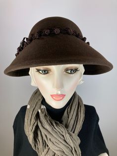 What a fun and different winter hat. This pretty espresso brown wool felt hat is hand blocked over vintage wooden hat blocks and hand sewn. The brim is narrow in the back and wider on the sides and front. This hat perches on the head rather than being worn down on the forehead. The band is a gorgeous vintage trim with tiny knots and is finished with a vintage velvet flower. What a classic vintage look! Handmade in the USA. In stock and ready to ship.++++++++++++++++++++++++++++++++++++++++++++++ Classic Winter Hat Ladies, Luxury Brown Cloche Hat With Curved Brim, Luxury Vintage Wool Hat, Fall Hats For Women Vintage, Felt Vintage Hats For Women, Luxury Brown Women's Cloche Hat, London In March, Hat For Winter, Womens Winter Dresses