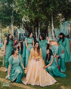 a group of women standing next to each other on top of a lush green field