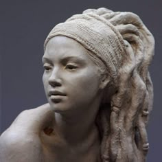 a statue of a woman with dreadlocks on her head