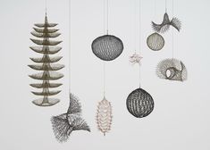 an installation view of abstract crocheted wire sculptures by Ruth Asawa