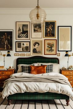 a bedroom with pictures on the wall above the bed and below the bed is a green upholstered bed