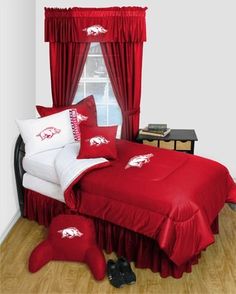 a red bed with white sheets and pillows