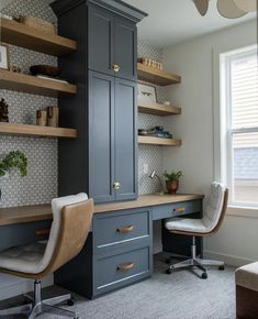 a home office with built - in shelving, desk and chair