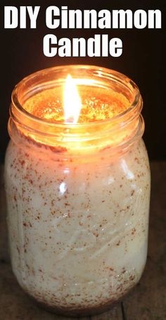 a lit candle sitting on top of a wooden table