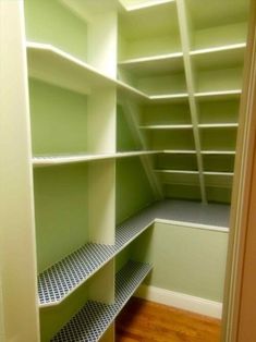 an empty walk in closet with lots of shelves