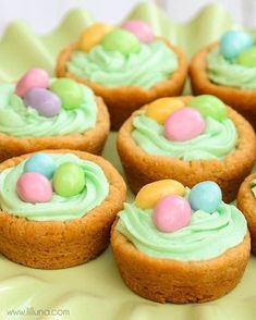 small cupcakes with green frosting and candy eggs