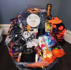 a basket filled with halloween items on top of a wooden floor