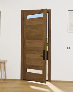 an open wooden door in a white room