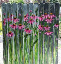 a painting of pink flowers on a wooden fence