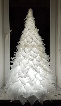 a white christmas tree made out of paper