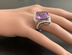 14.70 Carats Natural Amethyst and Diamond 14K Solid White Gold Ring Suggested Replacement Value: Approx. $5,500.00 Total Natural Square Cushion Shaped Amethyst Weights: Approx. 14.00 Carats Amethyst Measures: Approx. 15.00 x 15.00mm Natural Round Diamonds Weight: Approx. 0.70 Carats (color G-H / Clarity SI1-SI2) Ring total weight: Approx. 12.0 grams Disclaimer: all weights, measurements and colors are approximate and may vary slightly from the listed dimensions or as seen in the image. All pictu Luxury Formal Hallmarked Gemstones, Luxury Formal Round Cut Gemstones, Luxury Round Cut Gemstones For Formal Occasions, Luxury Round Cut Gemstones For Formal Events, Luxury Cushion Cut Amethyst Ring For Formal Occasions, Luxury Amethyst Cushion Cut Ring For Formal Occasions, Luxury Amethyst Cushion Cut Ring For Formal Events, Luxury Amethyst Gemstones With Accent Stones, Luxury White Gold Amethyst Ring