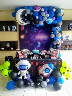 an astronaut themed birthday party with balloons and decorations