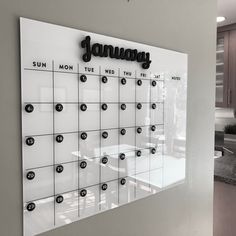 a wall mounted calendar with the word january on it