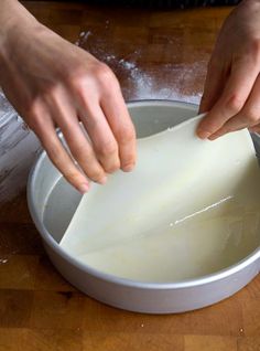 a person is cutting up some food in a bowl