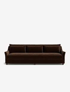 a brown couch sitting on top of a white floor