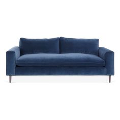 a blue couch sitting on top of a white floor