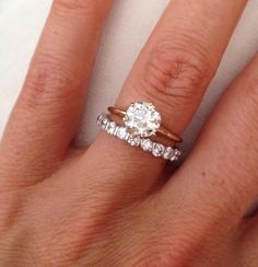 a woman's hand with a ring on it and a diamond in the middle