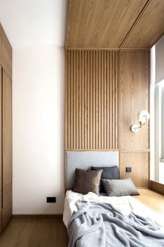 a bedroom with wood paneling and white walls