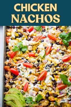 chicken nachos with black beans, corn and avocado in a casserole dish