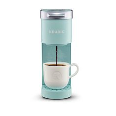 the keurig single serve coffee maker is shown with its cup filled with liquid