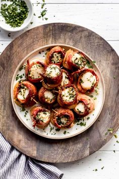 small appetizers are served on a plate next to a bowl of seasoning