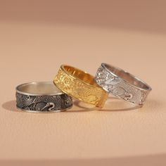 three different rings sitting on top of a table