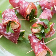 several appetizers are arranged on a green plate