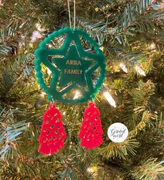 an ornament hanging from a christmas tree with the name abra family on it