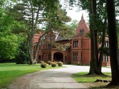 a large red brick building surrounded by trees