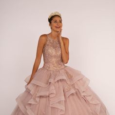 The Delightful Dress Made In The Silhouette Of Ball Gown Has A Structural Top With Halter Neckline Decorated With Delicate Patterns That Together With Sparkling Rhinestones Will Create A Beautiful Image Of A Princess. Fabric: Tulle Length: Long Colour: Mauve Neckline: Halter Silhouette: Ball Gown Sleeve: Sleeveless Back: Sheer, Zipper Skirt: Ruffled Embellishments: Lace, Rhinestones Occasion: Romantic Date/Evening/Dinner, Wedding/Bridesmaid, Graduation, Fashion Show, Visiting Theater/Museum/Rest Sleeveless Ruffled Ball Gown For Quinceanera, Sleeveless Gown With Ruffles For Quinceanera, Sleeveless Ruffled Gown For Quinceanera, Sleeveless Organza Quinceanera Dress, Sleeveless Ruffle Dress For Debutante Ball, Organza Ruffle Dress For Quinceanera, Sleeveless Organza Ball Gown With Ruffles, Sleeveless Ruffled Ball Gown For Gala, Sleeveless Gown With Ruffles For Debutante Ball