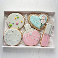 decorated cookies in a box on a table