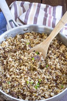 a pan filled with rice and meat on top of a table