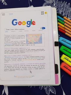 an open notebook with several crayons on it