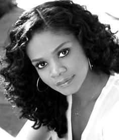 a black and white photo of a woman with curly hair