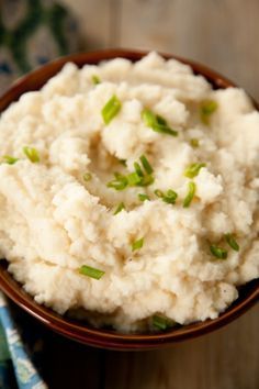 a bowl filled with mashed potatoes on top of a table