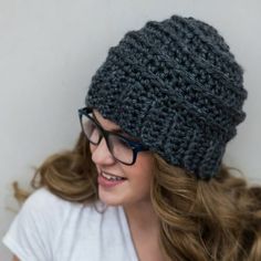 a woman wearing glasses and a knitted hat