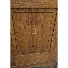 a wooden cabinet with an ornate design on the door