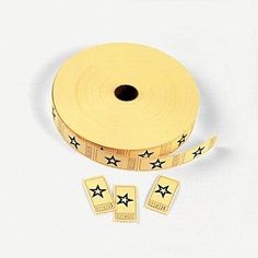 two rolls of gold colored tape with black stars on the side and one roll is yellow