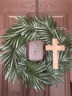 a wreath with a cross hanging on it