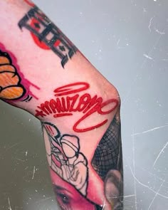 a close up of a person's leg with tattoos on it and writing that reads,