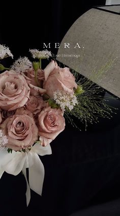 a bouquet of pink roses and white carnations