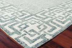 a blue and white rug on top of a wooden floor