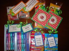 the contents of a school supply bag are displayed on a table with ribbons and tags