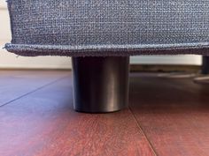 a close up view of the back end of a chair with wood flooring on it