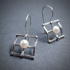 Bridal Pearl Earrings 925. Very elegant geometric earrings made out of Silver 925 and natural freshwater Pearl. You can choose between two different sizes.  If you want to make them a set, here is the matching pendant: https://www.etsy.com/listing/258712074/silver-handmade-pendant-with-pearl?ga_search_query=pendant%2Bsquare&ref=shop_items_search_2&frs=1 Details: Material: Sterling Silver 925 and Pearls 5 mm diameter (0.2 inch) Width: 16mm (5/8 inch) Length: Choose between two options A 35mm (1 3 Modern Drop Pearl Earrings As Gift, Modern White Gold Pearl Earrings Gift, Modern White Gold Pearl Earrings For Gift, Sterling Silver Pearl Earrings Gift, Modern Pearl Earrings For Gift, Modern White Gold Pearl Earrings In Sterling Silver, Modern White Gold Sterling Silver Pearl Earrings, Modern Sterling Silver Pearl Earrings For Pierced Ears, Gift Pearl Earrings In Sterling Silver