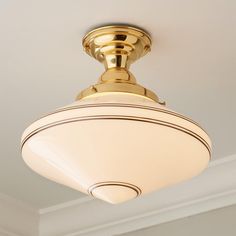 a close up of a light fixture on a ceiling in a room with white walls