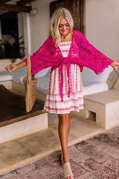 - Set sail in this beautiful crochet tie top! - Hot pink colored crochet material - Loose, three-quarter length sleeves - Open draped silhouette that ends in an uneven hemline perfect for front tie closure Pink Lace Crochet Dress For Summer, Pink Crochet Top With Crochet Trim For Beach, Pink Bohemian Crochet Dress, Pink Lace Crochet Top For Beach, Pink Lace Crochet Top For The Beach, Pink Crochet Top For Spring Vacation, Pink Crochet Lace Top For Spring, Pink Open Knit Crochet Top For Beach, Spring Vacation Pink Crochet Top