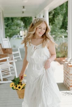 Dress to impress in our classic summer sundress, the White Eyelet Lace Midi Dress. This stunning dress features delicate eyelet lace with feminine ruffle detailing and a flattering tiered design. Sleeveless and with real tie at the scoop neckline, you'll look effortlessly chic in this beautiful white dress. Perfect for any occasion or just out running errands, this dress will make you stand out in style! runs true to size with a loose fit full elastic waist 52" from the shoulder to the hem model, Ashlyn is wearing a size small Summer Dresses With Broderie Anglaise And Tiered Skirt, Summer Tiered Broderie Anglaise Dresses, Summer Broderie Anglaise Tiered Skirt Dresses, Summer Broderie Anglaise Tiered Dress, Beautiful White Dress, Beautiful White Dresses, Boutique Trends, Summer Sundress, Lace Midi