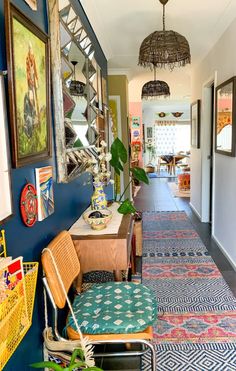 the hallway is decorated with colorful rugs and pictures on the walls, along with wicker chairs