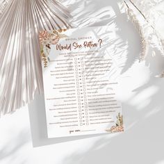 a bridal shower checklist on a white background with flowers and palm leaves around it